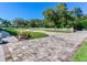 Landscaped yard with brick pavers and a white fence at 1503 Limona Rd, Brandon, FL 33510
