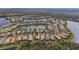 Stunning aerial view of a residential community with lake, lush landscaping and beautiful homes at 16127 Cape Coral Dr, Wimauma, FL 33598