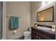 Cozy bathroom featuring a dark wood vanity and a neutral color scheme at 16127 Cape Coral Dr, Wimauma, FL 33598