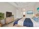 Comfortable bedroom with tray ceiling, television, and stylish decor at 16127 Cape Coral Dr, Wimauma, FL 33598