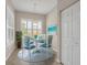 Charming breakfast nook featuring a round table with seating for four, bright natural light, and coastal wall art at 16127 Cape Coral Dr, Wimauma, FL 33598