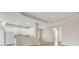 Open floor plan featuring a kitchen with white cabinets, stainless appliances, and a breakfast bar overlooking the living area at 16127 Cape Coral Dr, Wimauma, FL 33598