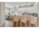 Eat-in kitchen featuring white cabinets, bar seating, and a dining area with a breakfast table at 16127 Cape Coral Dr, Wimauma, FL 33598