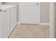 Bright laundry room featuring a white washer and dryer set with neutral tile flooring at 16127 Cape Coral Dr, Wimauma, FL 33598