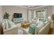 Comfortable living room with bright furnishings, natural light and sliding glass doors that lead to an outdoor patio at 16127 Cape Coral Dr, Wimauma, FL 33598