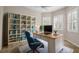 Bright home office with custom shelving, a comfortable workspace, and natural light at 16127 Cape Coral Dr, Wimauma, FL 33598