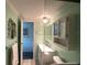Clean bathroom with a vanity, medicine cabinet, and tiled shower at 1710 7Th Sw St # 83, Ruskin, FL 33570