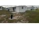 Side view of the home and surrounding yard at 1710 7Th Sw St # 83, Ruskin, FL 33570