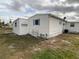 Rear view of the home, showing a detached shed at 1710 7Th Sw St # 83, Ruskin, FL 33570