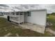 Side of the mobile home with a lattice-fenced patio and storage area at 1710 7Th Sw St # 83, Ruskin, FL 33570