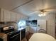 Bright kitchen features ample cabinetry, stainless steel appliances, and granite countertops at 1710 7Th Sw St # 83, Ruskin, FL 33570
