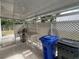 Outdoor patio area with grill, trash cans, and privacy screen at 1710 7Th Sw St # 83, Ruskin, FL 33570