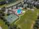 Aerial view of community pool, tennis courts, and playground at 17443 Glenapp Dr, Land O Lakes, FL 34638