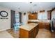 Island kitchen with granite countertops and wood cabinets at 17443 Glenapp Dr, Land O Lakes, FL 34638