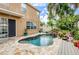 Inviting pool area with stone deck and waterfall at 17443 Glenapp Dr, Land O Lakes, FL 34638
