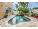 Freeform pool with stone deck and waterfall feature at 17443 Glenapp Dr, Land O Lakes, FL 34638