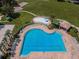 Community pool with surrounding lounge chairs and playground at 17443 Glenapp Dr, Land O Lakes, FL 34638