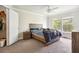 Bedroom with wood frame bed, walk-in closet, and large windows at 18119 Sterling Gate Cir # 18119, Tampa, FL 33647