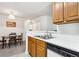 Kitchen with light wood cabinets, white countertops, and a dining area at 18119 Sterling Gate Cir # 18119, Tampa, FL 33647