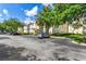 View of apartment building with parking lot and landscaping at 18119 Sterling Gate Cir # 18119, Tampa, FL 33647