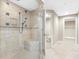 Bathroom with tiled shower, glass door, and a bench at 19734 Gulf Blvd # 202, Indian Shores, FL 33785