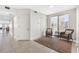 Hallway with tile floors that leads to a sitting area with a window view of the beach and ocean at 19734 Gulf Blvd # 202, Indian Shores, FL 33785