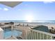 Stunning balcony view of the ocean, beach, and pool at 19734 Gulf Blvd # 202, Indian Shores, FL 33785