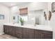 Double vanity bathroom with gray cabinets and quartz countertops at 20237 Bandera Pl, Venice, FL 34293