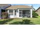 House exterior with a screened porch and manicured lawn at 20922 Jaffa Ln, Land O Lakes, FL 34637
