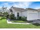 Single-story villa with attached garage and landscaped front yard at 20922 Jaffa Ln, Land O Lakes, FL 34637
