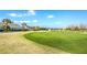 Golf course green with sand trap and clubhouse in background at 20922 Jaffa Ln, Land O Lakes, FL 34637