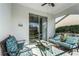 Cozy screened porch with seating area, offering tranquil backyard views at 20922 Jaffa Ln, Land O Lakes, FL 34637