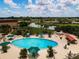 Aerial view of a community pool and surrounding landscape at 2501 Sapphire Greens Ln, Sun City Center, FL 33573