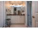 Double vanity bathroom with granite countertop and modern lighting at 2501 Sapphire Greens Ln, Sun City Center, FL 33573