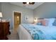 King-size bedroom with a ceiling fan and window shutters at 2501 Sapphire Greens Ln, Sun City Center, FL 33573