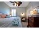 King-size bedroom with a ceiling fan and window shutters at 2501 Sapphire Greens Ln, Sun City Center, FL 33573