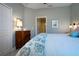King-size bedroom with a ceiling fan and window shutters at 2501 Sapphire Greens Ln, Sun City Center, FL 33573