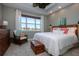 Main bedroom with lake view and ceiling fan at 2501 Sapphire Greens Ln, Sun City Center, FL 33573