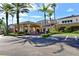 Community clubhouse with covered entryway and palm trees at 2501 Sapphire Greens Ln, Sun City Center, FL 33573