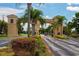Gated community entrance with palm trees and landscaping at 2501 Sapphire Greens Ln, Sun City Center, FL 33573