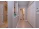 Clean and bright hallway with tile floors and storage at 2501 Sapphire Greens Ln, Sun City Center, FL 33573