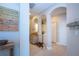 Bright hallway with decorative arches and coat rack at 2501 Sapphire Greens Ln, Sun City Center, FL 33573