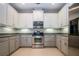 Modern kitchen with stainless steel appliances and granite countertops at 2501 Sapphire Greens Ln, Sun City Center, FL 33573
