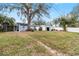 Spacious backyard with shed and large tree providing shade at 2755 Morningside Dr, Clearwater, FL 33759