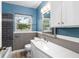 Updated bathroom with white vanity, gray tile, and new fixtures at 2755 Morningside Dr, Clearwater, FL 33759
