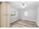 Simple bedroom with light walls, wood flooring, and ceiling fan at 2755 Morningside Dr, Clearwater, FL 33759