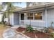 Inviting front porch with white railings and landscaping at 2755 Morningside Dr, Clearwater, FL 33759