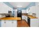 Modern kitchen with white cabinets, butcher block countertops, and stainless steel appliances at 2755 Morningside Dr, Clearwater, FL 33759