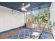 Relaxing screened porch with wood floors and outdoor furniture at 2755 Morningside Dr, Clearwater, FL 33759