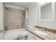Updated bathroom with granite countertop and tile shower/tub at 3303 Brigadoon Dr, Clearwater, FL 33759
